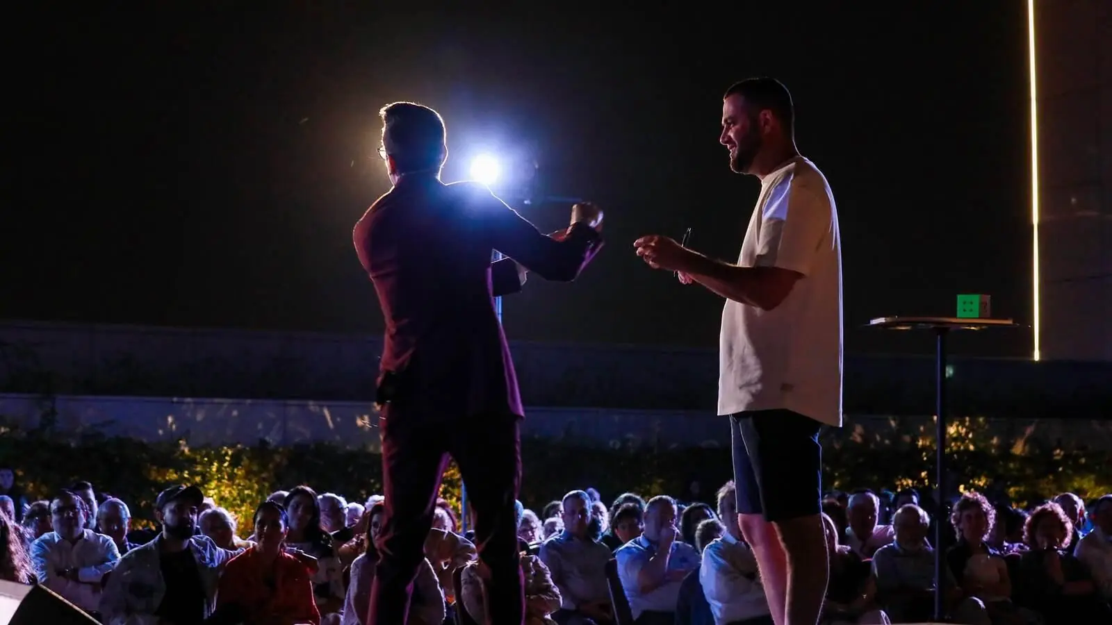 A hushed crowd at a night show